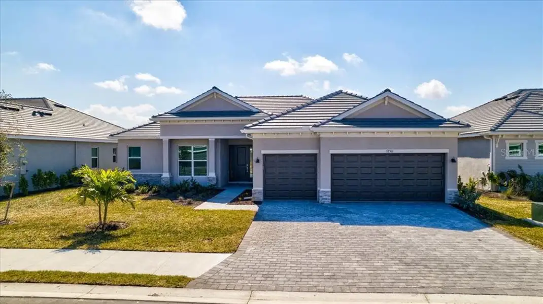 Front exterior of a new home in Harbor East, Port Charlotte, FL, highlighting curb appeal (Image 2).