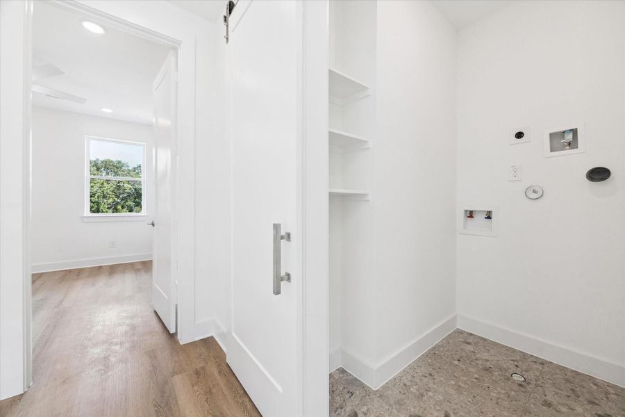 Lastly on the third floor is a laundry closet set up for a stackable washer and dryer. It includes a smart little space with a few shelves and room for an ironing board or perhaps the perfect spot to add a clothes hanging rod. Lastly on the third floor is a laundry closet set up for a stackable washer and dryer. It includes a smart little space with a few shelves and room for an ironing board or perhaps the perfect spot to add a clothes hanging rod.