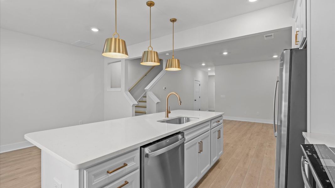 Elegant and compact island anchors this tasteful kitchen with high standards and timeless appeal at Gresham Station