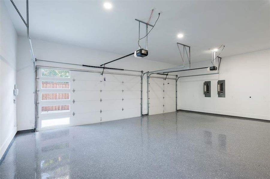 Garage featuring a garage door opener and electric panel