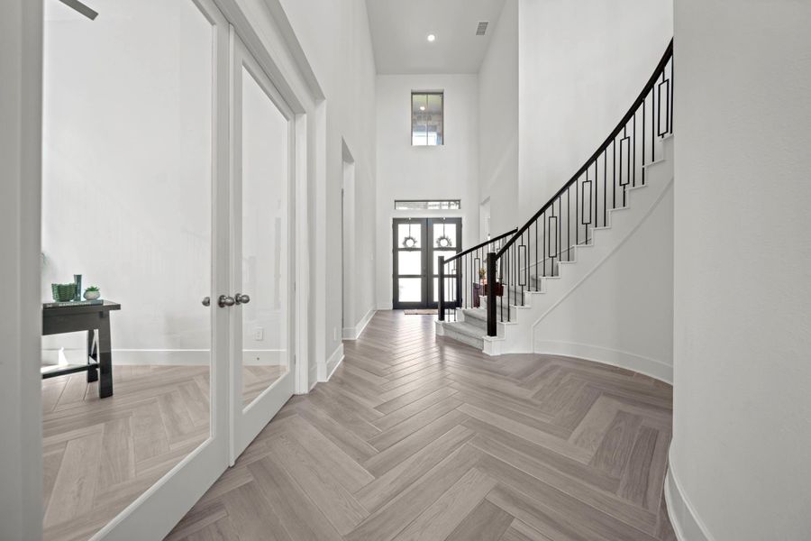 Looking back toward the front doors, tall ceilings and French doors to the study show off the home’s thoughtful design. Looking back toward the front doors, tall ceilings and French doors to the study show off the home’s thoughtful design.