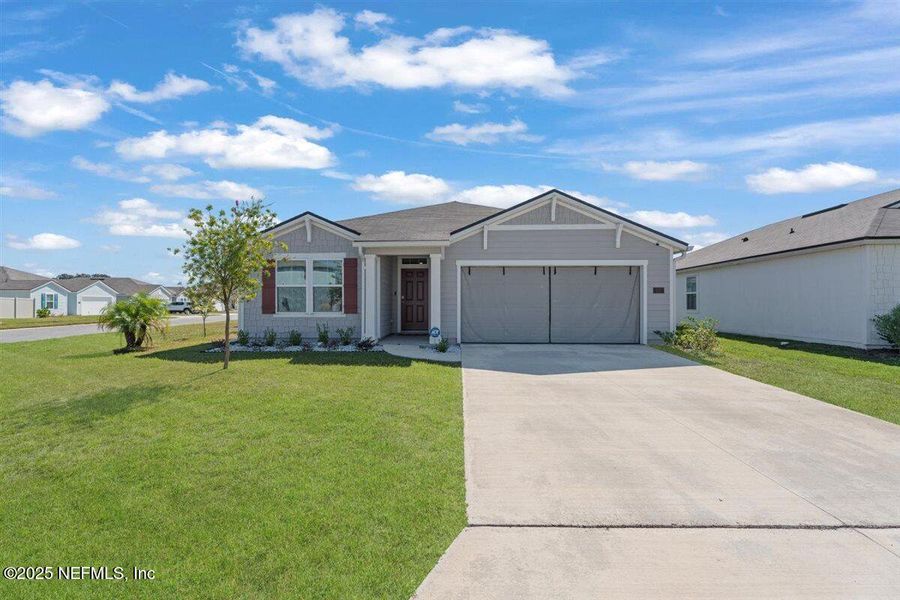 Front exterior of a new home in Dorado at Entrada, St. Augustine, FL, highlighting curb appeal (Image 23). Front exterior of a new home in Dorado at Entrada, St. Augustine, FL, highlighting curb appeal (Image 23).