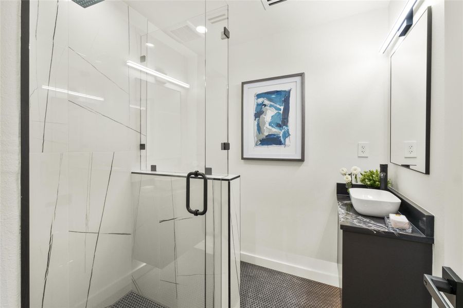 Full bathroom featuring a shower, vanity, baseboards, and tile patterned flooring