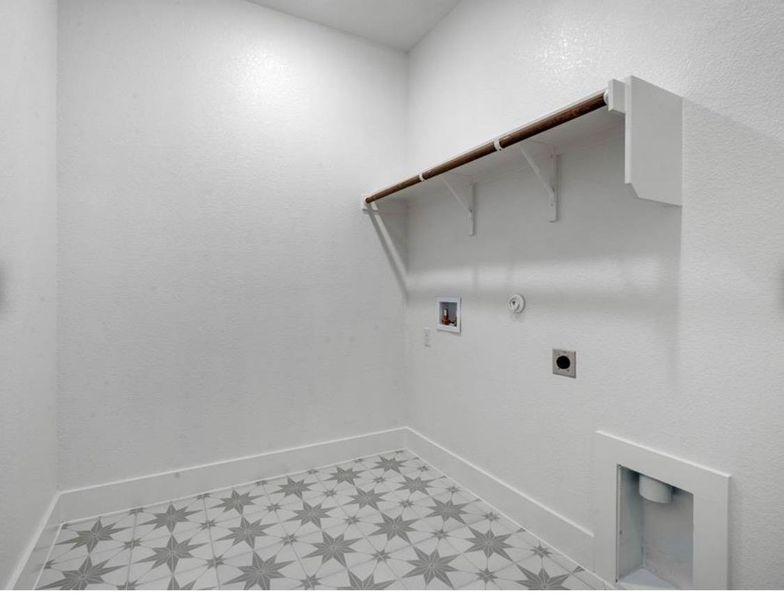Laundry room with light floors, hookup for a gas dryer, hookup for a washing machine, and electric dryer hookup