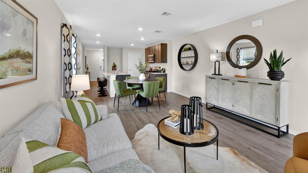 Open-concept living space featuring wood-finish flooring, recessed lighting, and light-toned walls Open-concept living space featuring wood-finish flooring, recessed lighting, and light-toned walls
