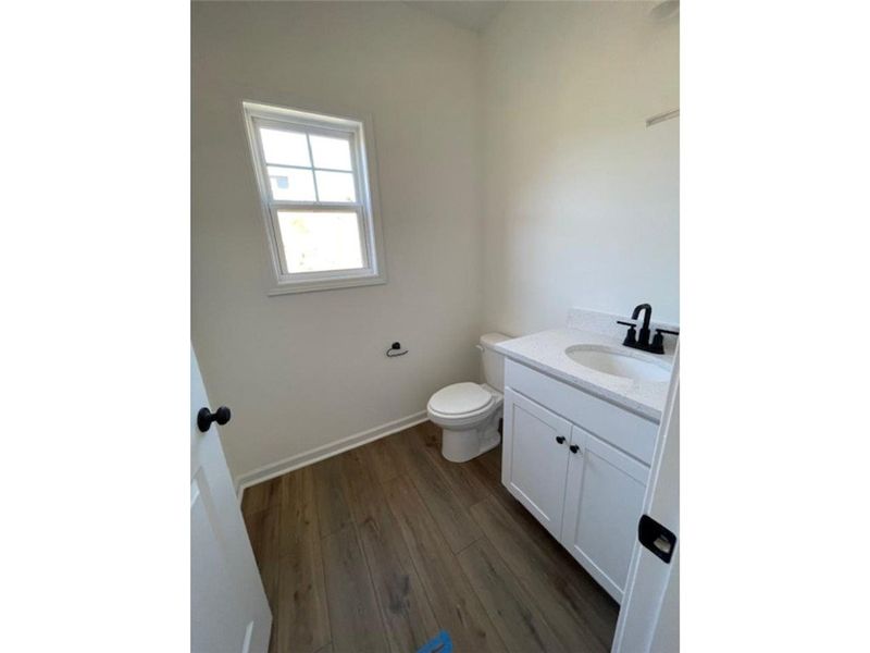 This clean, bright bathroom features ample light a