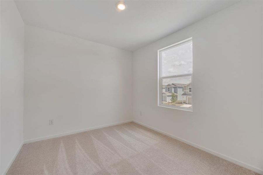 Empty room with light colored carpet