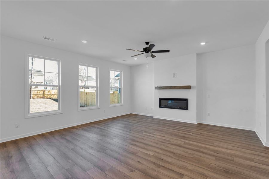 This living room features rich wood flooring, larg