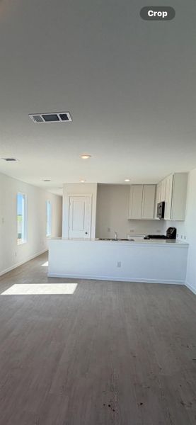 Unfurnished living room featuring dark wood finished floors and recessed lighting Unfurnished living room featuring dark wood finished floors and recessed lighting