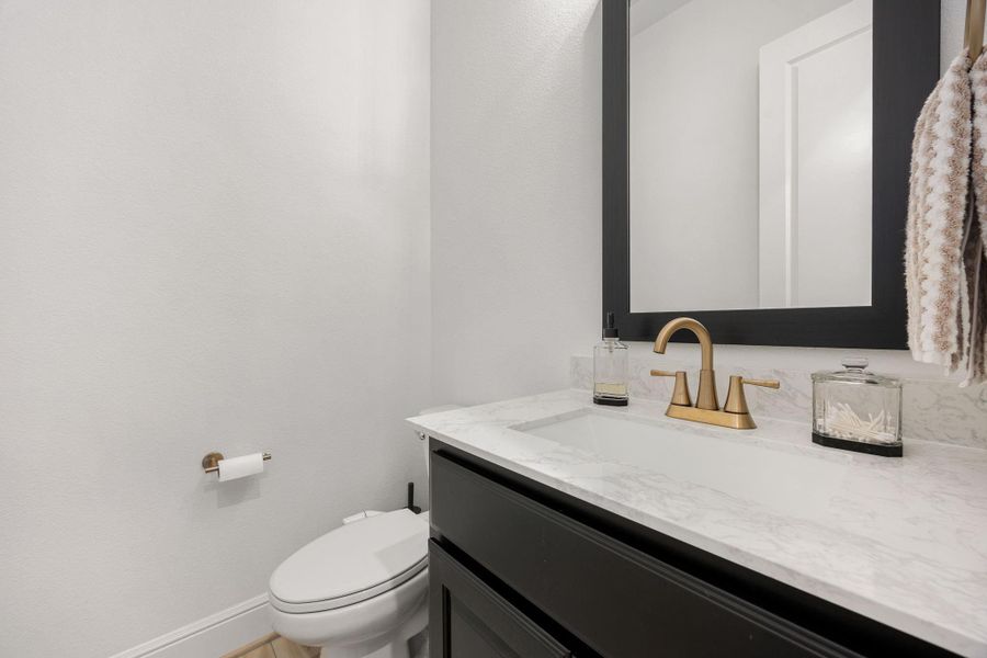 The powder bath features a stylish vanity and a clean, modern design.