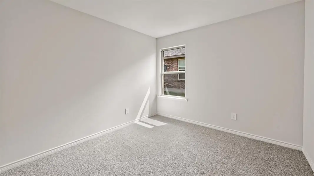 Neutral wall paint, light-colored carpet flooring, white baseboards, and a single window with a white frame Neutral wall paint, light-colored carpet flooring, white baseboards, and a single window with a white frame