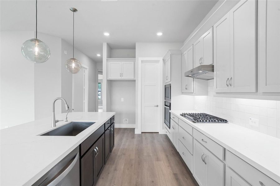 The heart of the home, a modern, highly functional kitchen that perfectly balances style and utility. Quartz countertops, complemented by a stylish backsplash, shaker-style cabinets provide ample storage, and the Whirlpool stainless steel appliances are all features of this beautiful kitchen!