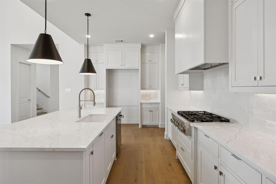 Crisp clean whites paired with dark striking trim and contemporary stainless steel come together to create the kitchen of your dreams!