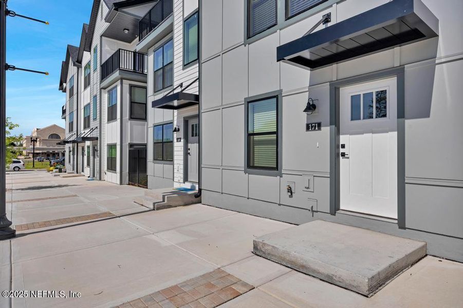 Front exterior of a new home in Johnson Commons, Jacksonville, FL, highlighting curb appeal (Image 20). Front exterior of a new home in Johnson Commons, Jacksonville, FL, highlighting curb appeal (Image 20).