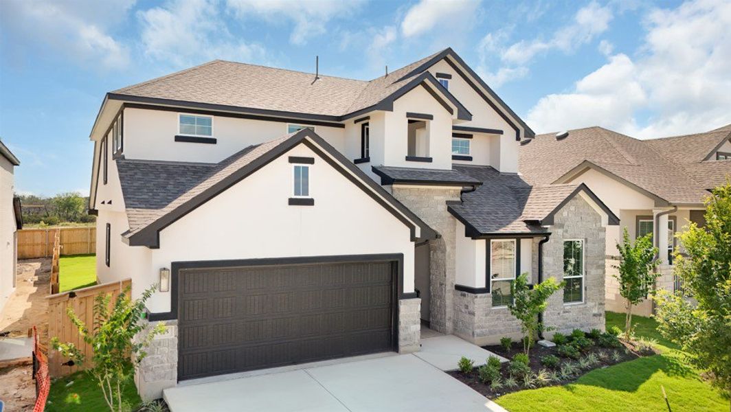 Front exterior of a new home in Lariat, Liberty Hill, TX, highlighting curb appeal (Image 29). Front exterior of a new home in Lariat, Liberty Hill, TX, highlighting curb appeal (Image 29).