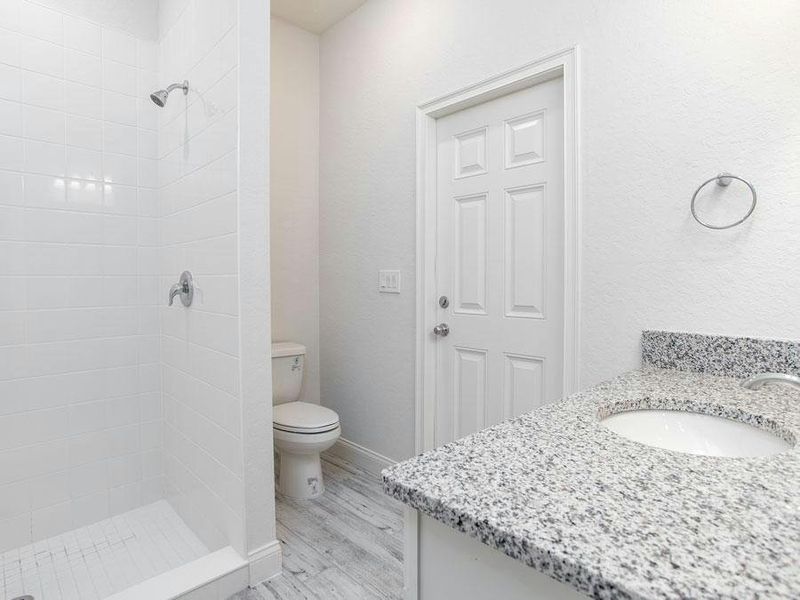 The in-law suite has en-suite access to Bath 3, and a pool door to the lanai - Willow II with Loft by Highland Homes