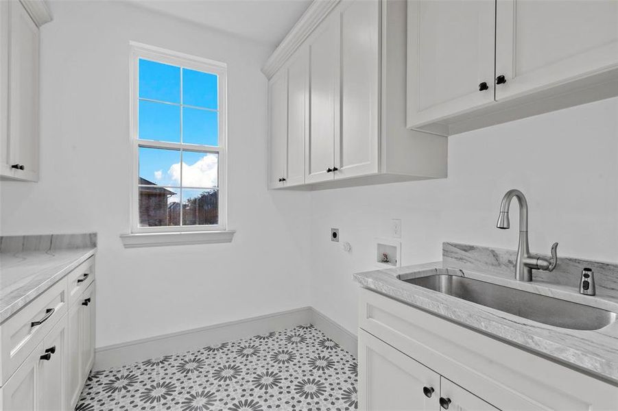 Laundry area featuring washer hookup, sink, cabinets, and hookup for an electric dryer