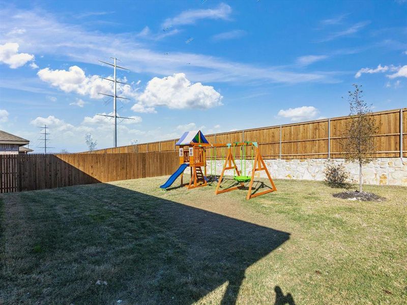 View of play area featuring a yard