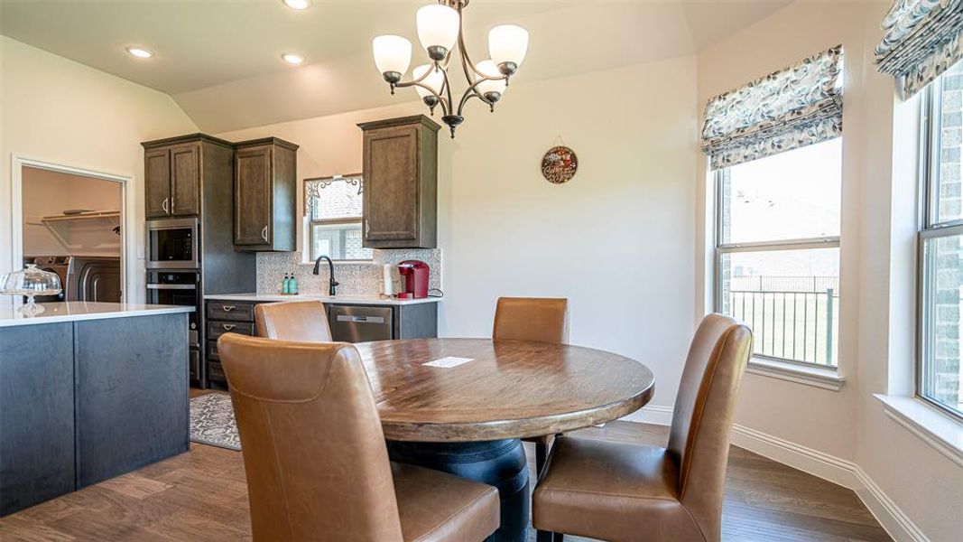 Dining area featuring a wood-finish round table and upholstered seating