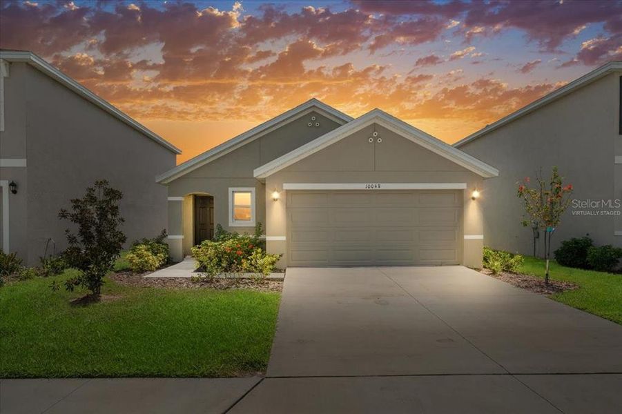 Front exterior of a new home in Bella Lago, Parrish, FL, highlighting curb appeal (Image 1).