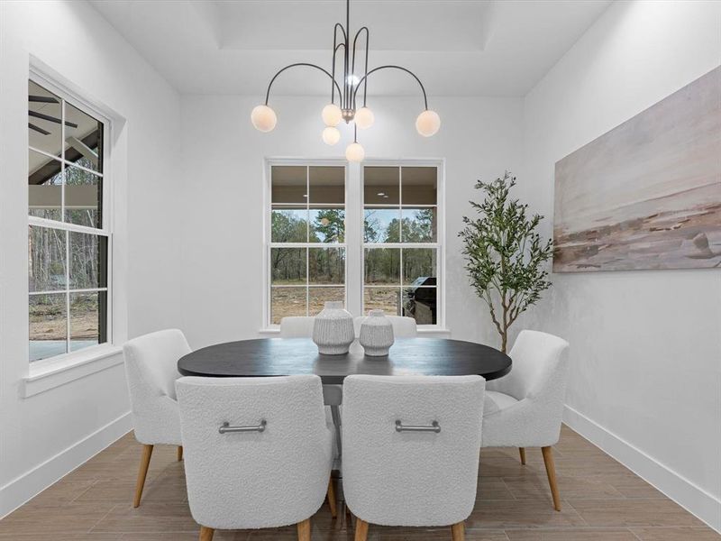 This formal dining space is perfectly sized, featuring large windows that enhance its ambiance.