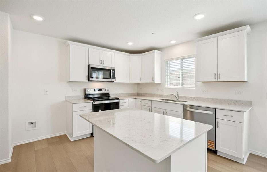 Large island overlooking gathering room and dining areas Large island overlooking gathering room and dining areas