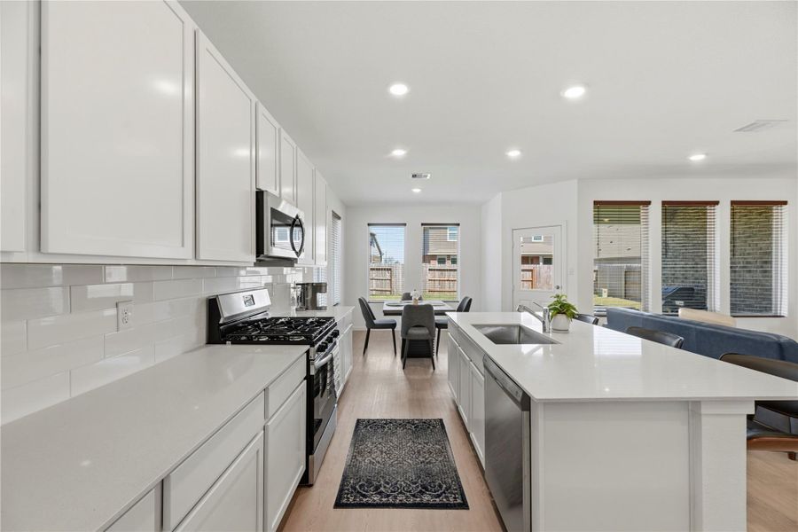 Kitchen featuring stainless steel appliances, gas range, and ample cabinetry.
