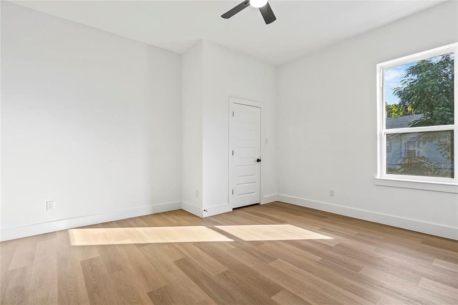 Spare room featuring light wood finished floors and a ceiling fan