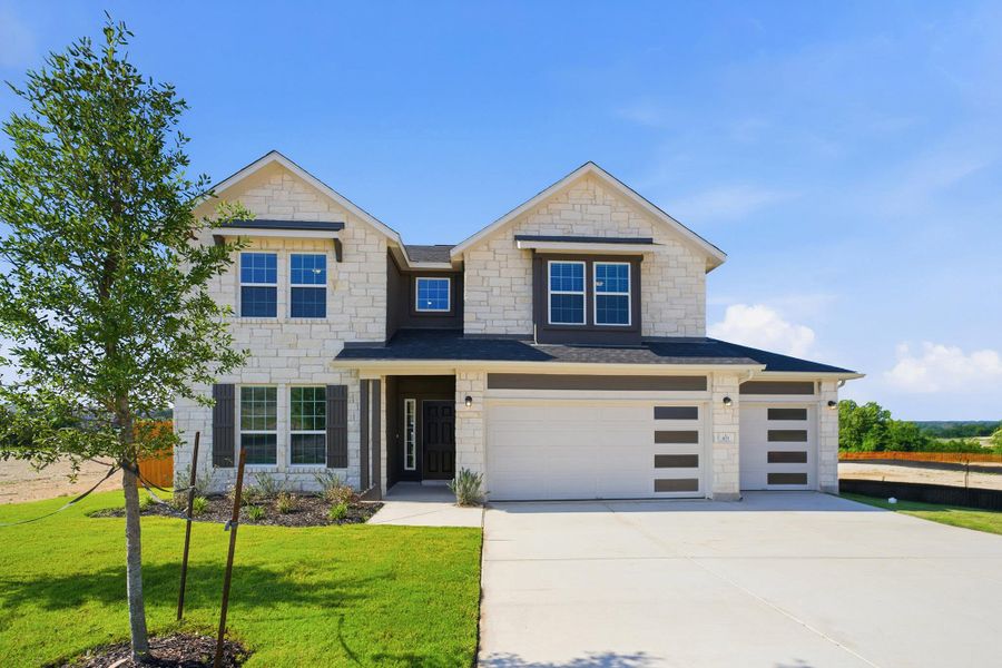 Front exterior of a new home in Lariat, Liberty Hill, TX, highlighting curb appeal (Image 1). Front exterior of a new home in Lariat, Liberty Hill, TX, highlighting curb appeal (Image 1).