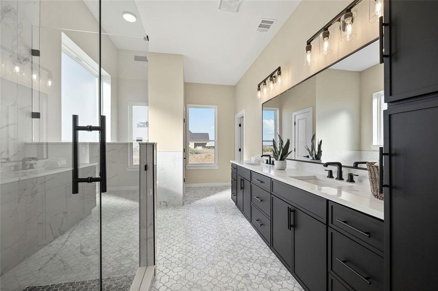 Bathroom with vanity, lofted ceiling, and a shower with door