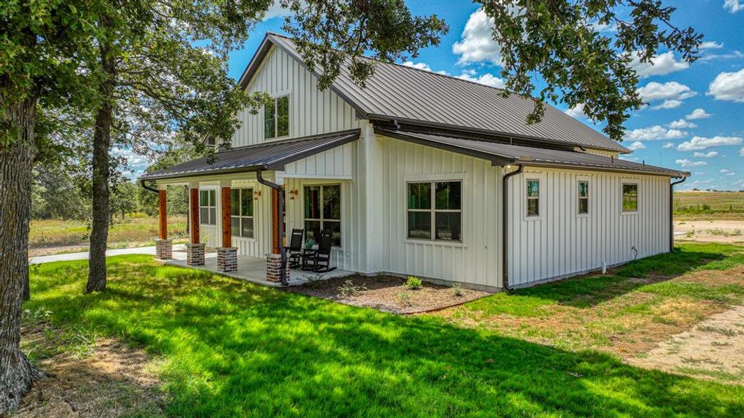 Sit on your shaded front porch with these lush trees surrounding you!