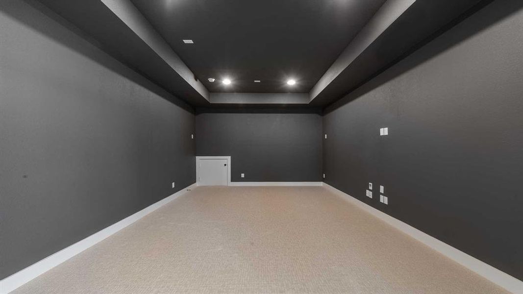 Spare room with light colored carpet, recessed lighting, and a tray ceiling