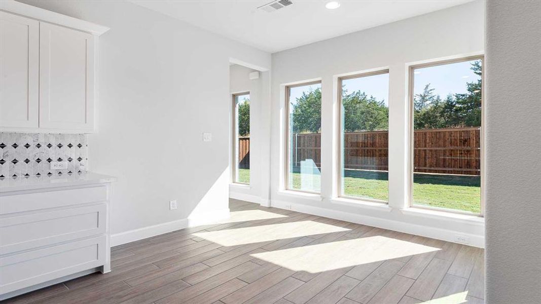 Unfurnished dining area with a healthy amount of sunlight and light hardwood / wood-style flooring