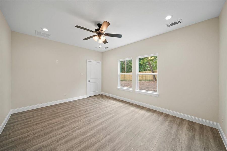 Empty room with ceiling fan and wood-type flooring