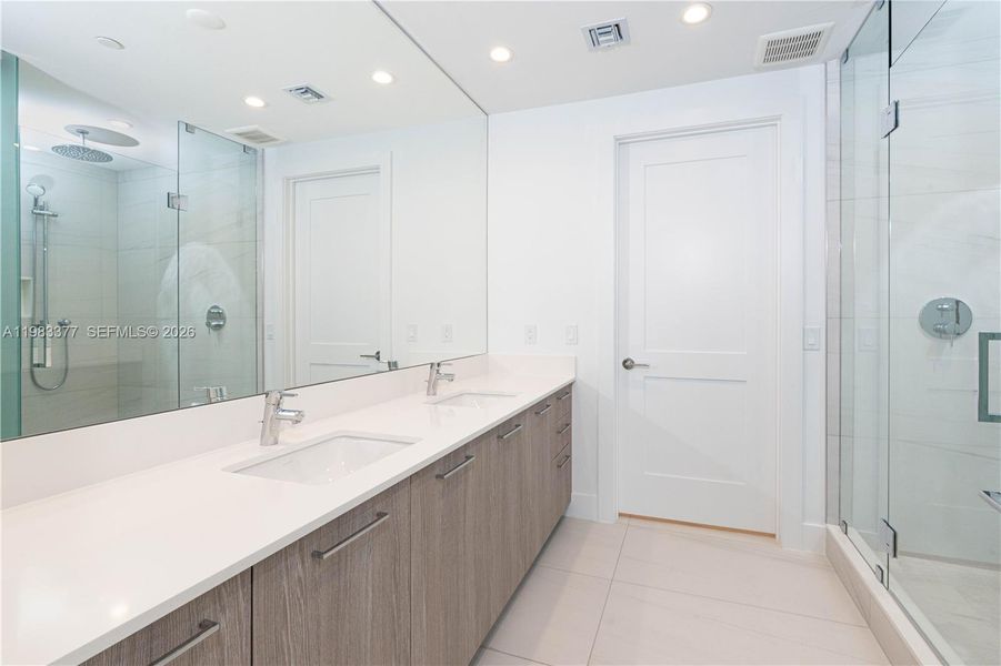 Master bathroom with dual sinks, shower