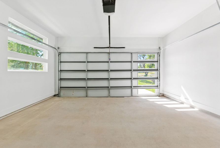 Garage featuring a garage door opener