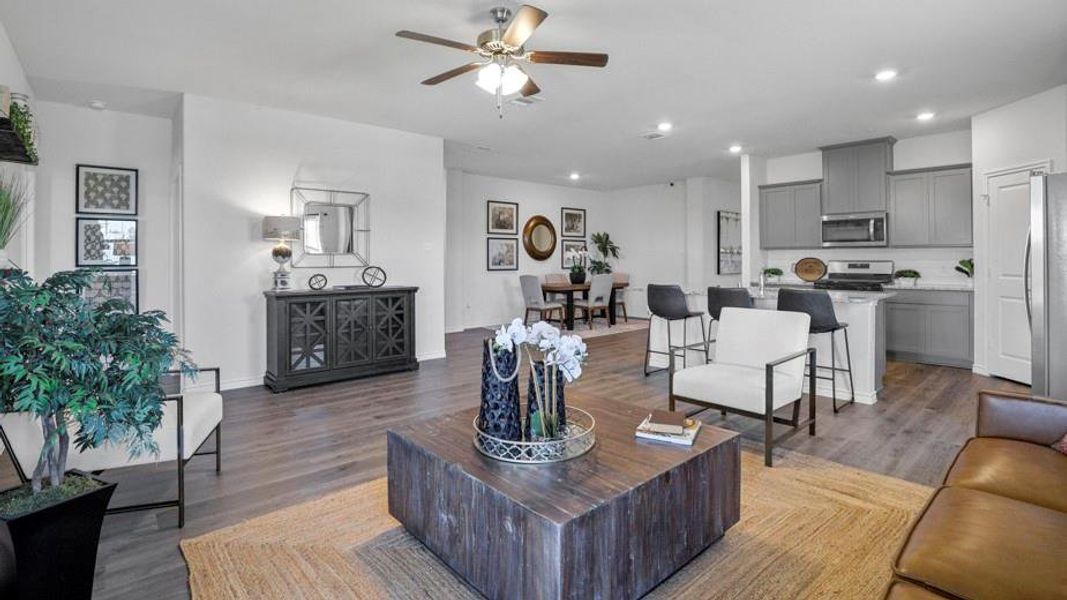 Living area with dark wood-style floors, a ceiling fan, and recessed lighting