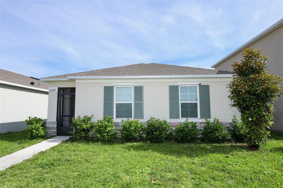 Front exterior of a new home in Windrose, Apopka, FL, highlighting curb appeal (Image 23).