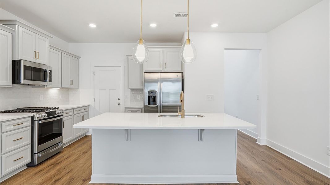 Memorable meals begin in this vibrant kitchen with pendant lighting and a thoughtfully designed island in Anderson, SC Memorable meals begin in this vibrant kitchen with pendant lighting and a thoughtfully designed island in Anderson, SC
