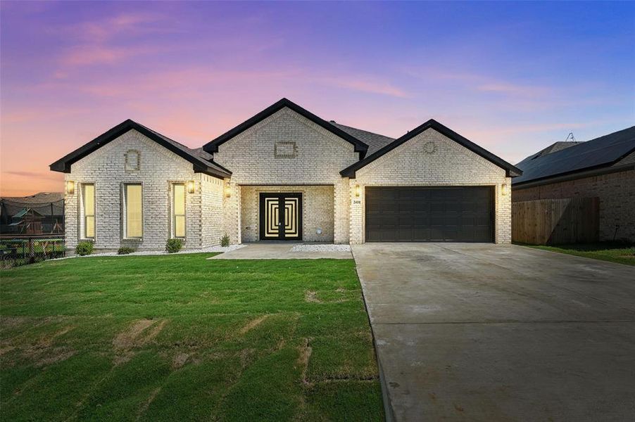 View of front of property with french doors, a garage, driveway, and brick siding View of front of property with french doors, a garage, driveway, and brick siding