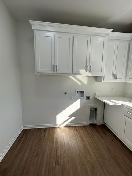 Laundry room featuring dark hardwood / wood-style floors, washer hookup, hookup for an electric dryer, and cabinets