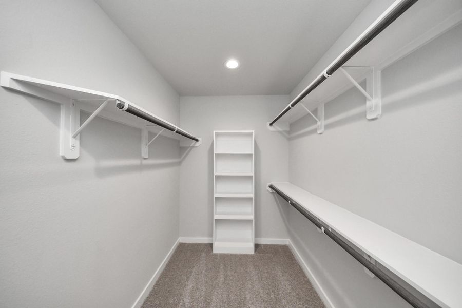 Walk-in closet that epitomizes luxury and practicality. This generously sized space features built-in shelving, offering abundant room for impeccable organization. High ceilings and recessed lighting create a bright and welcoming ambiance. Walk-in closet that epitomizes luxury and practicality. This generously sized space features built-in shelving, offering abundant room for impeccable organization. High ceilings and recessed lighting create a bright and welcoming ambiance.