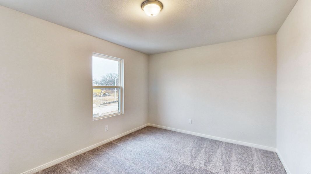 A room with a window and a carpet.