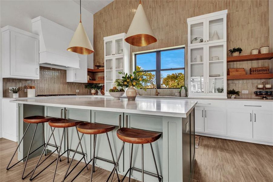 Kitchen featuring open shelves, white cabinets, backsplash, and hanging light fixtures Kitchen featuring open shelves, white cabinets, backsplash, and hanging light fixtures