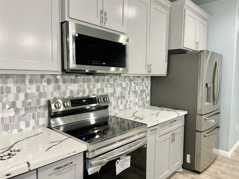 A well-appointed kitchen showcasing contemporary appliances and stylish countertops.