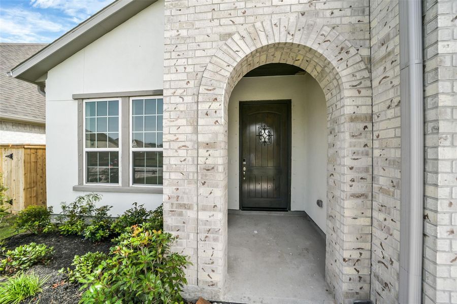 Front exterior of a new home in Del Bello Lakes 60', Manvel, TX, highlighting curb appeal (Image 23). Front exterior of a new home in Del Bello Lakes 60', Manvel, TX, highlighting curb appeal (Image 23).