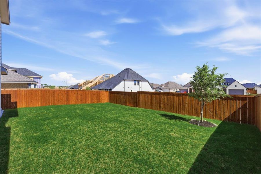 Fenced backyard with a residential view