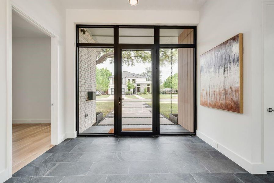 The foyer is filled with natural light, creating a calm and inviting first impression.