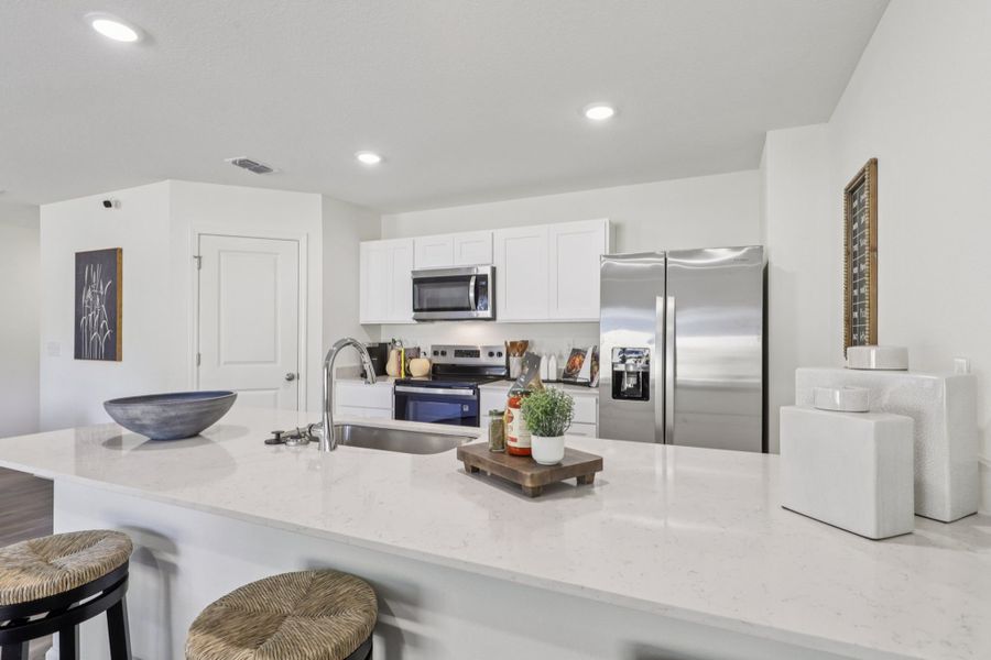 A kitchen with white cabinets. A kitchen with white cabinets.