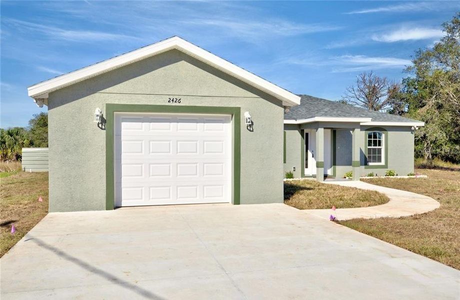 Front exterior of a new home in , Avon Park, FL, highlighting curb appeal (Image 2). Front exterior of a new home in , Avon Park, FL, highlighting curb appeal (Image 2).